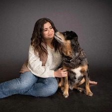 Mikayla-female posing next to a large multi colored brown dog